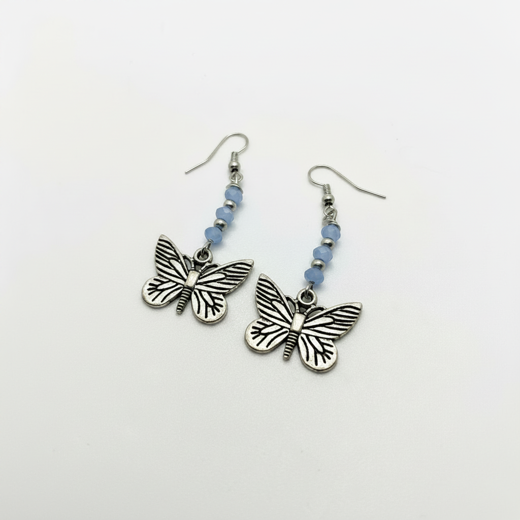 Butterfly dangle earrings with silver butterfly charms and light blue faceted beads